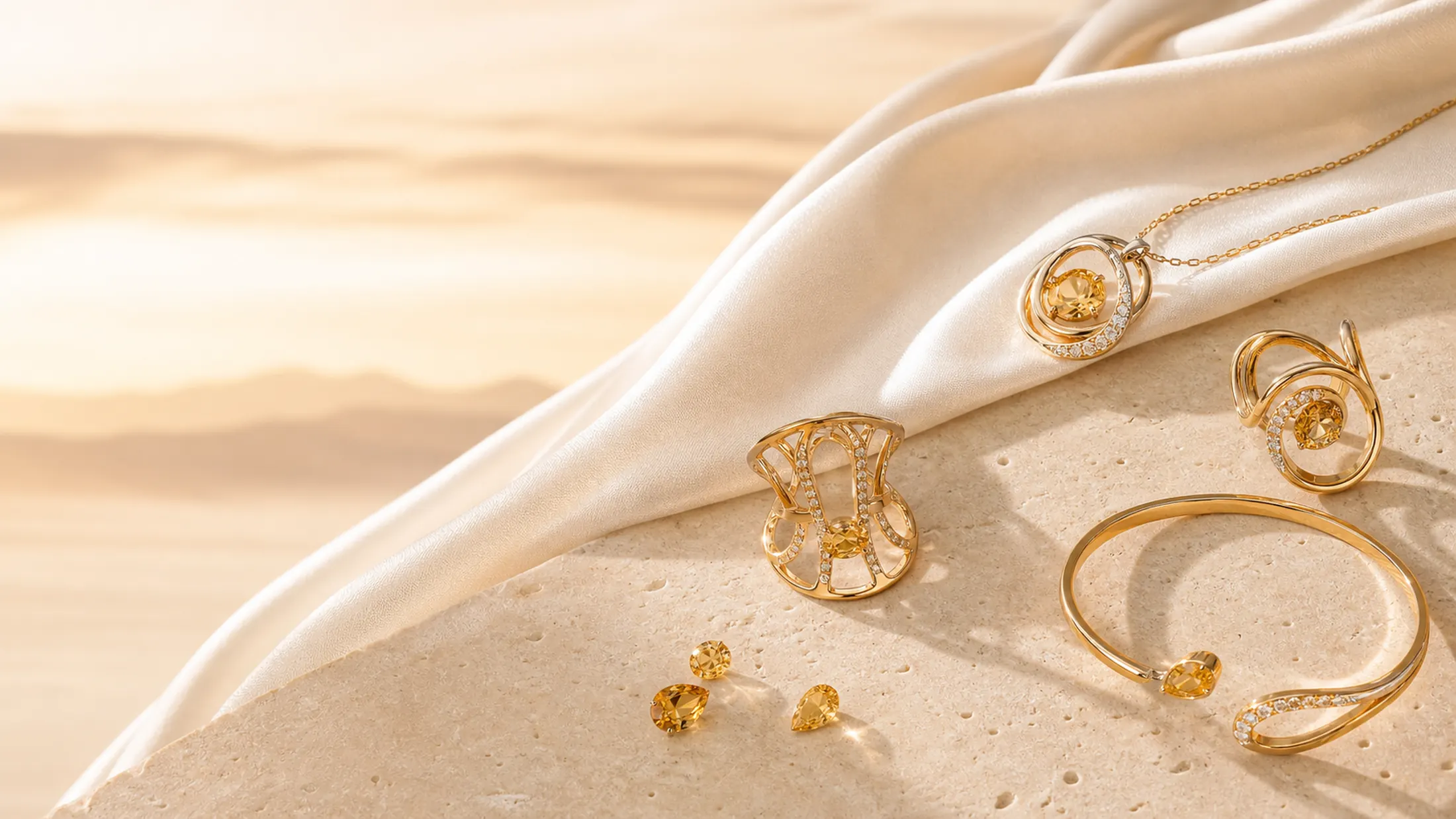 Golden gemstones and warm gold forms arranged for the Desert Light collection